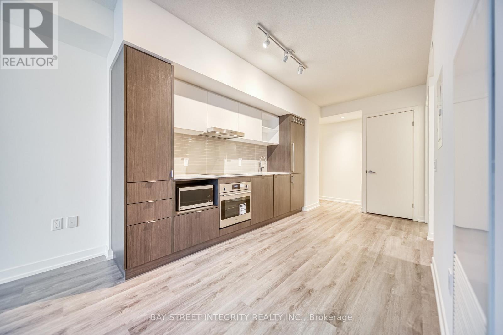 A modern kitchen with wooden cabinets and appliances.