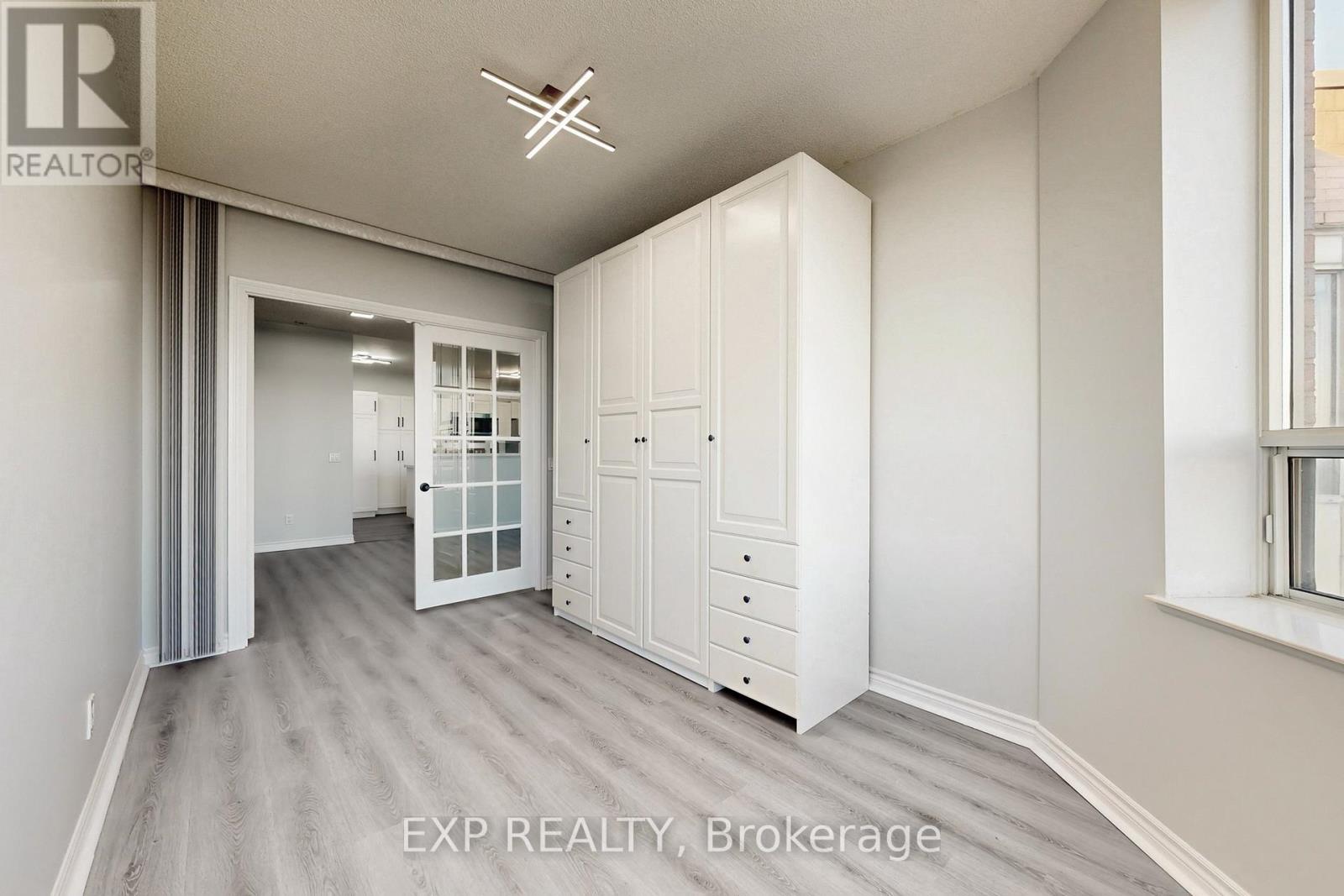 A spacious room with a large closet and a window.