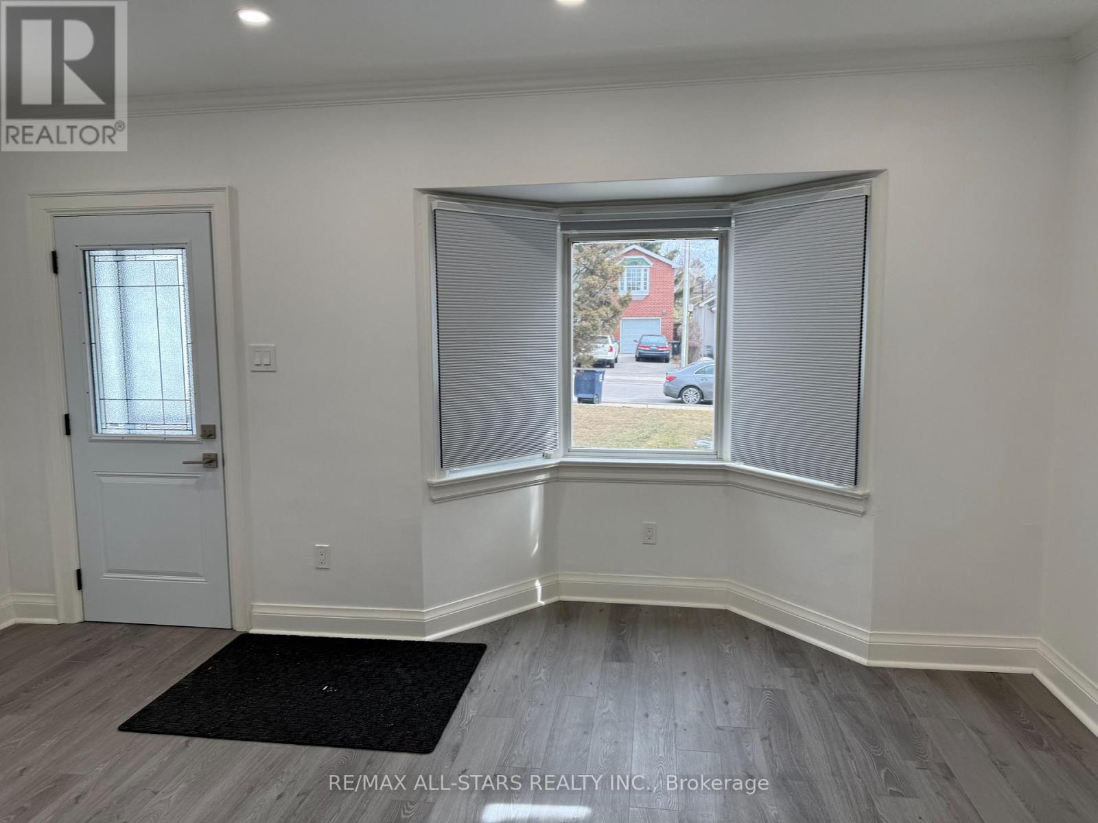 A room with a window and a door.
