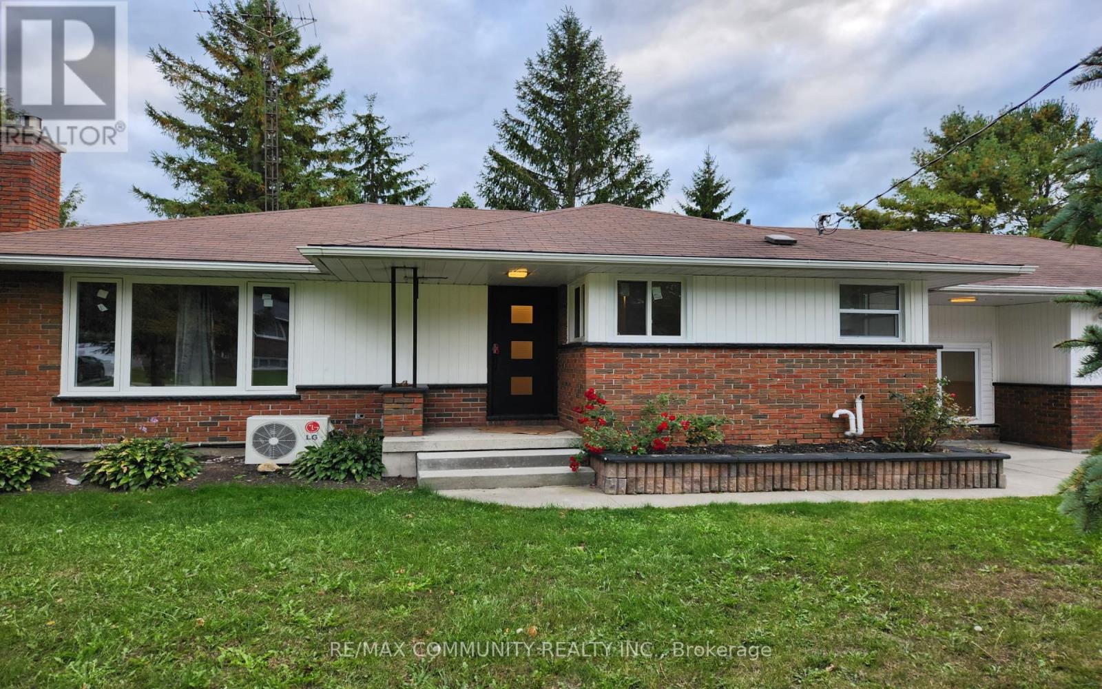 A house with a brown roof and a brick chimney is for sale.