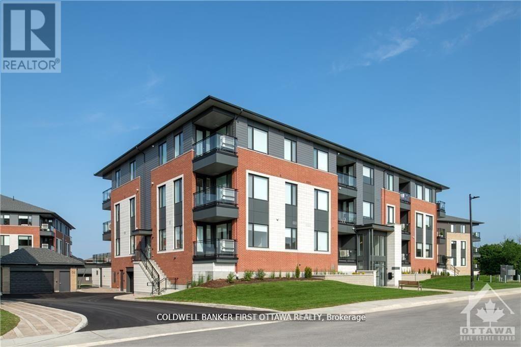 A modern apartment building with a clear blue sky in the background.