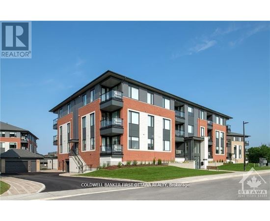 A modern apartment building with a clear blue sky in the background.
