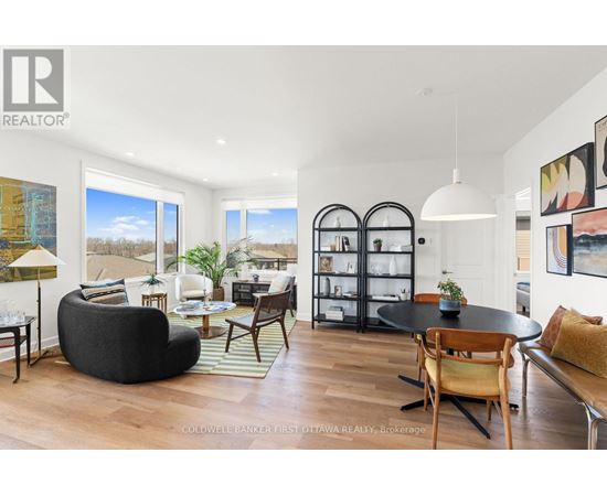 A modern living room with a black bean bag chair and a glass cabinet.
