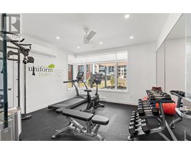 A gym room with a treadmill, exercise bike, and weights.