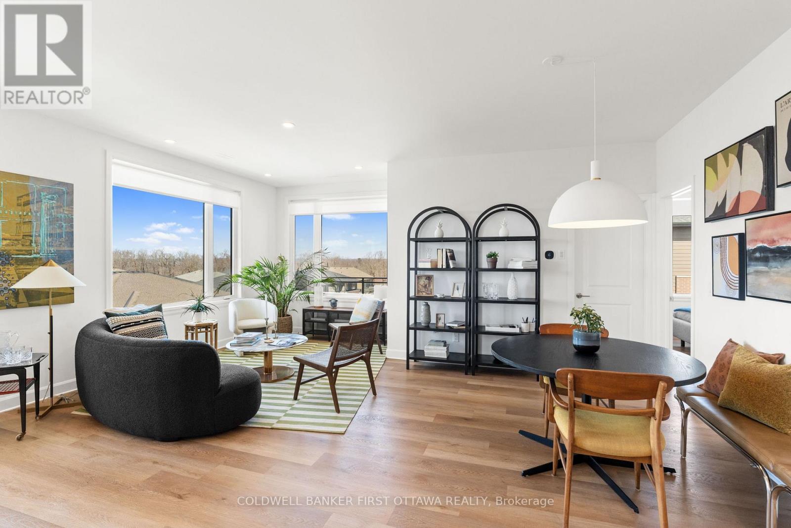 A modern living room with a black bean bag chair and a glass cabinet.