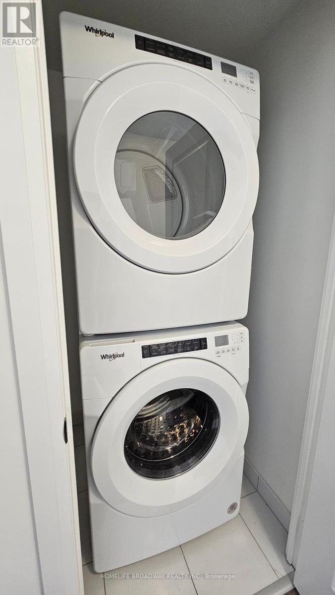Two white Whirlpool washing machines in a small laundry room.