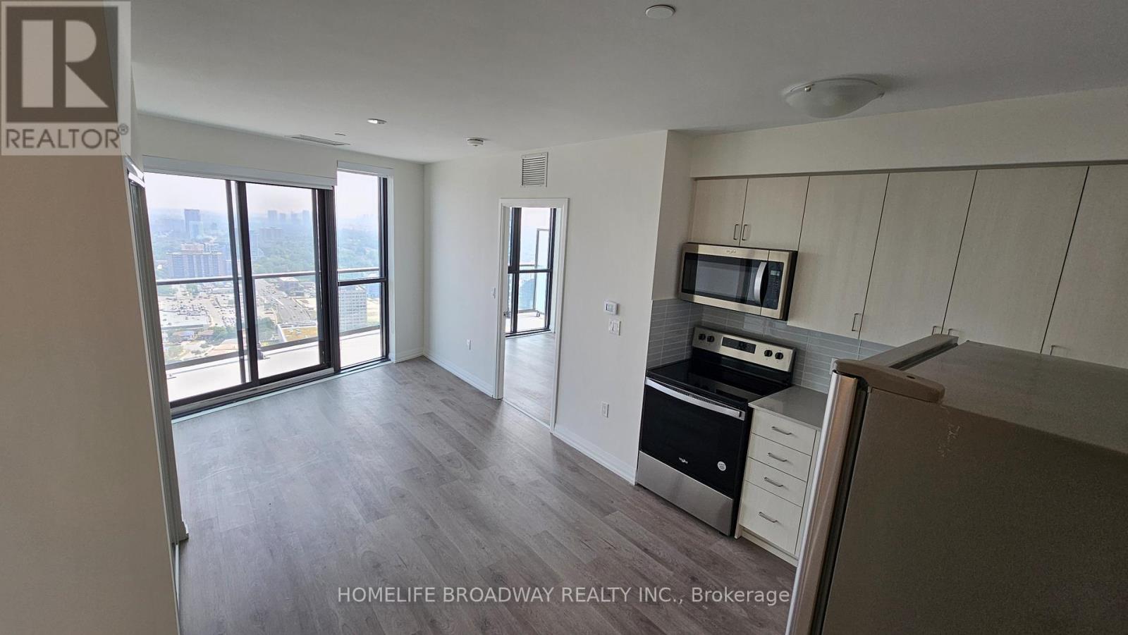 A spacious kitchen with a microwave and oven built into the cabinetry.