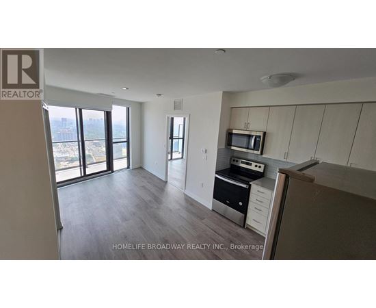 A spacious kitchen with a microwave and oven built into the cabinetry.
