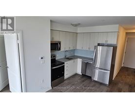 A kitchen with white cabinets and stainless steel appliances.