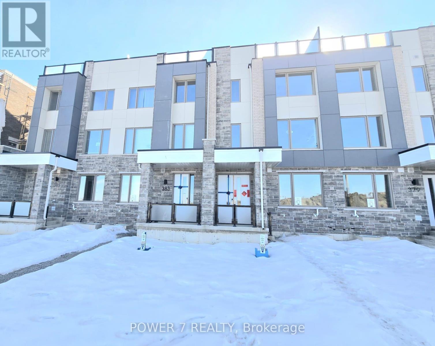 A building with the text "POWER 7 REALTY, Brokerage" in front of it.