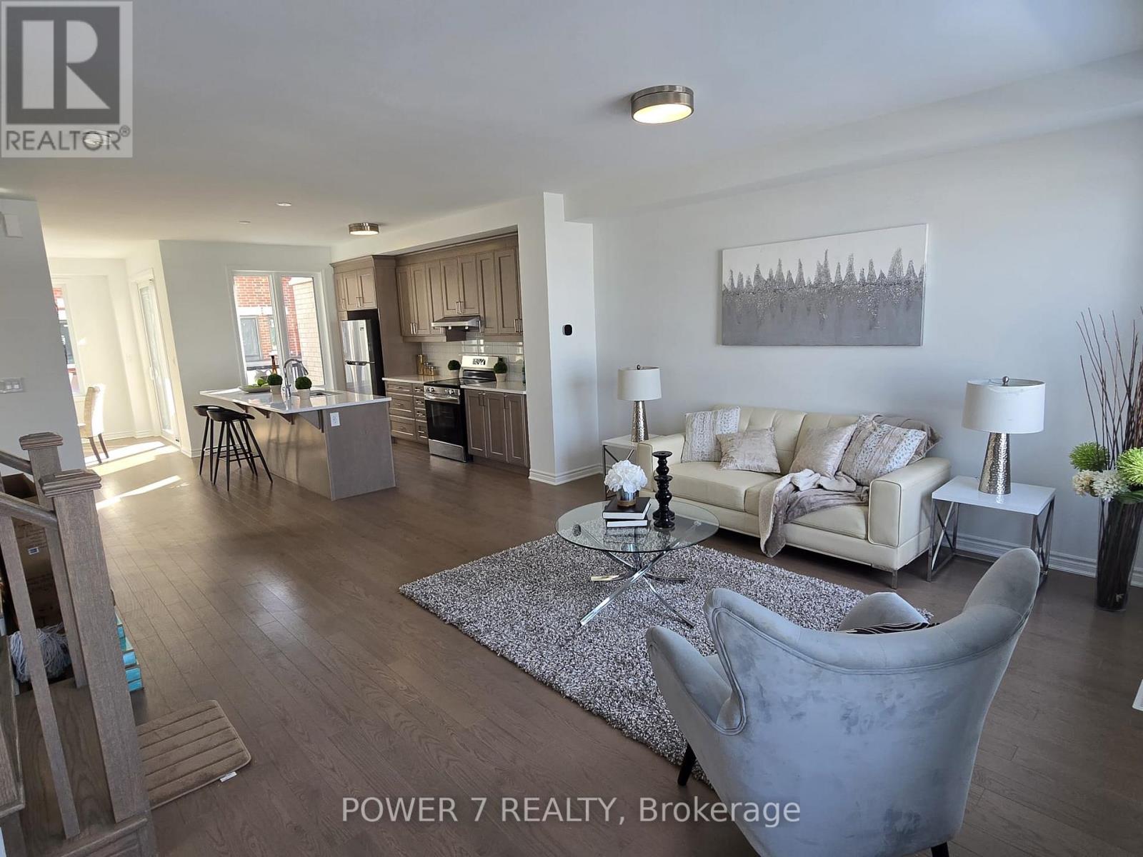 A living room with a grey couch and a coffee table in the middle.