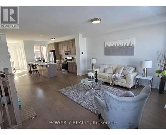 A living room with a grey couch and a coffee table in the middle.