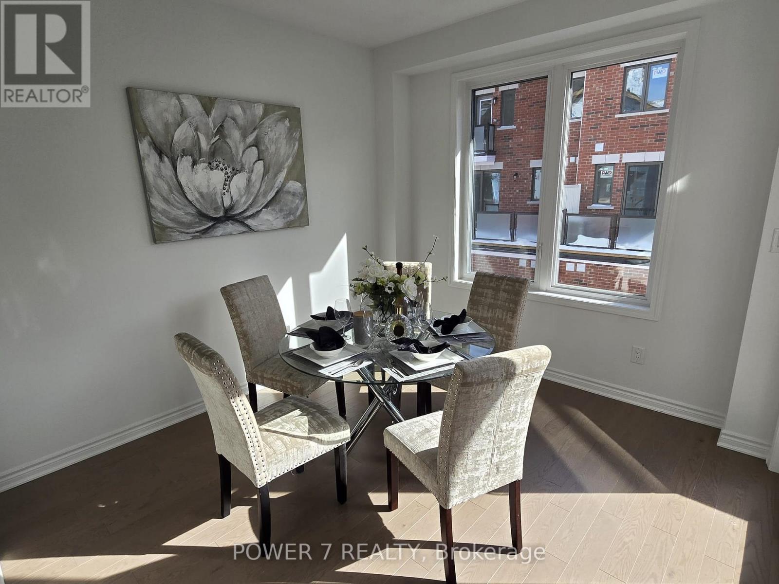 A dining room with a table set for four.