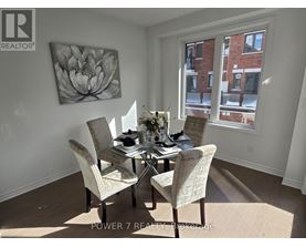 A dining room with a table set for four.