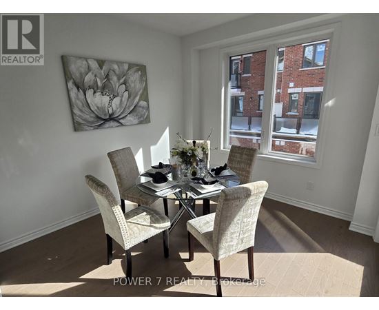 A dining room with a table set for four.