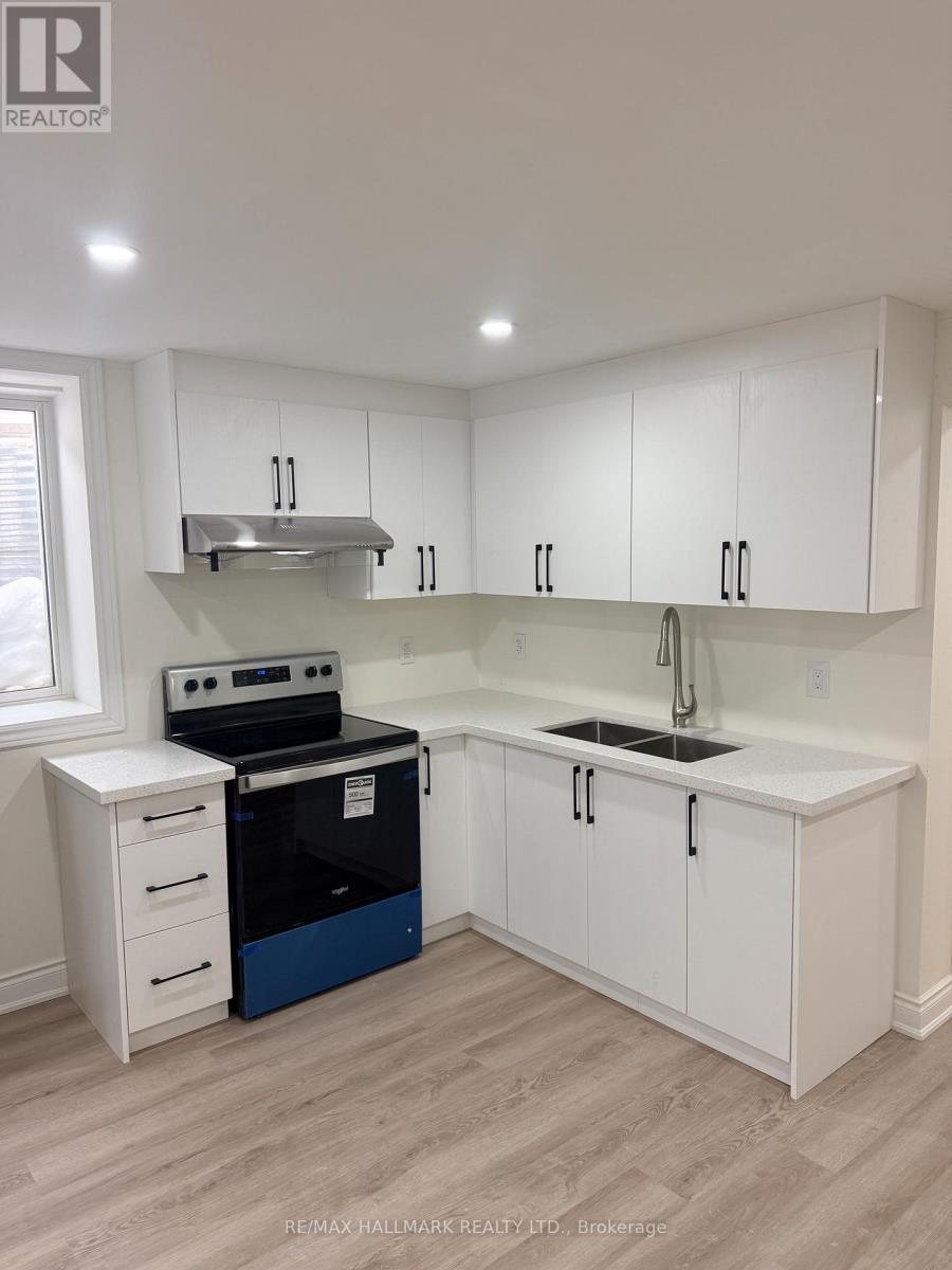 A kitchen with white cabinets and a blue dishwasher.