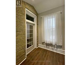 A room with a window and a curtain.