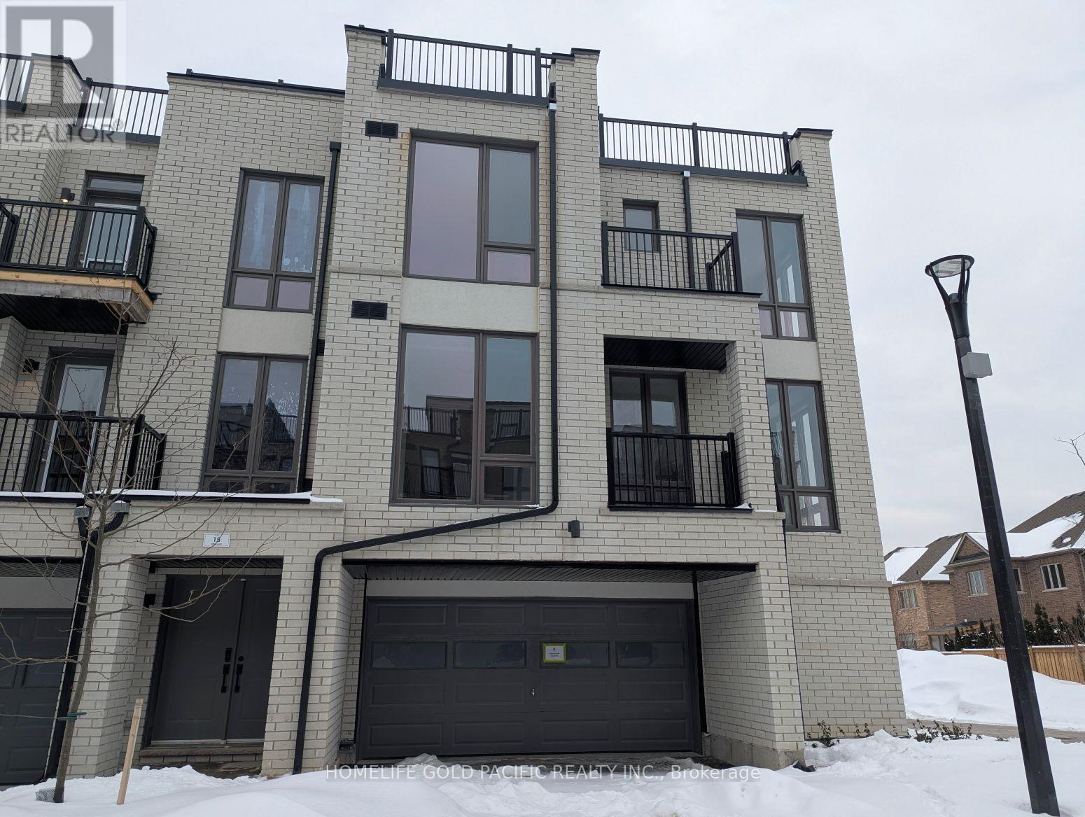 A multi-story building with balconies and a garage door.