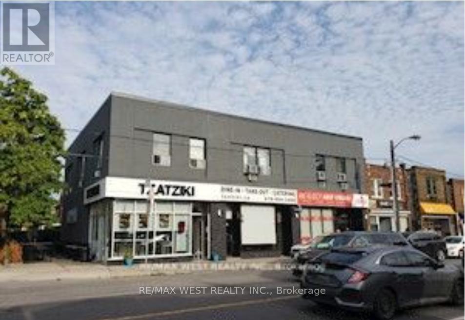 A car is parked in front of a building with a sign that says TAZZKI.