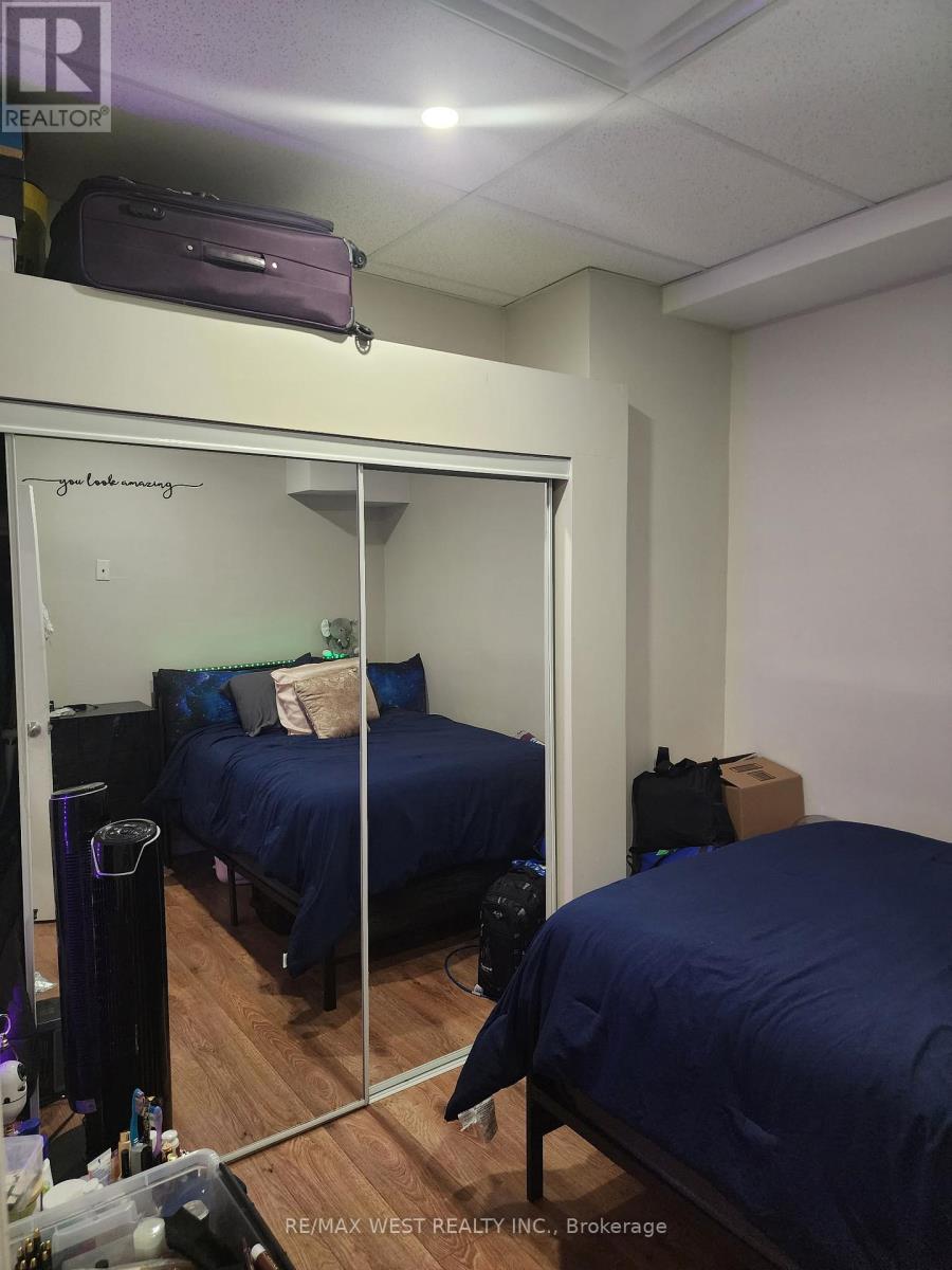 A bedroom with two beds and a mirror.