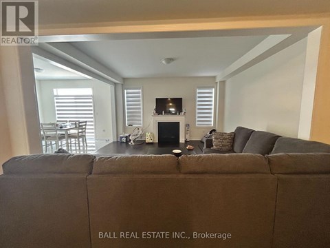 A living room with a couch and a fireplace.