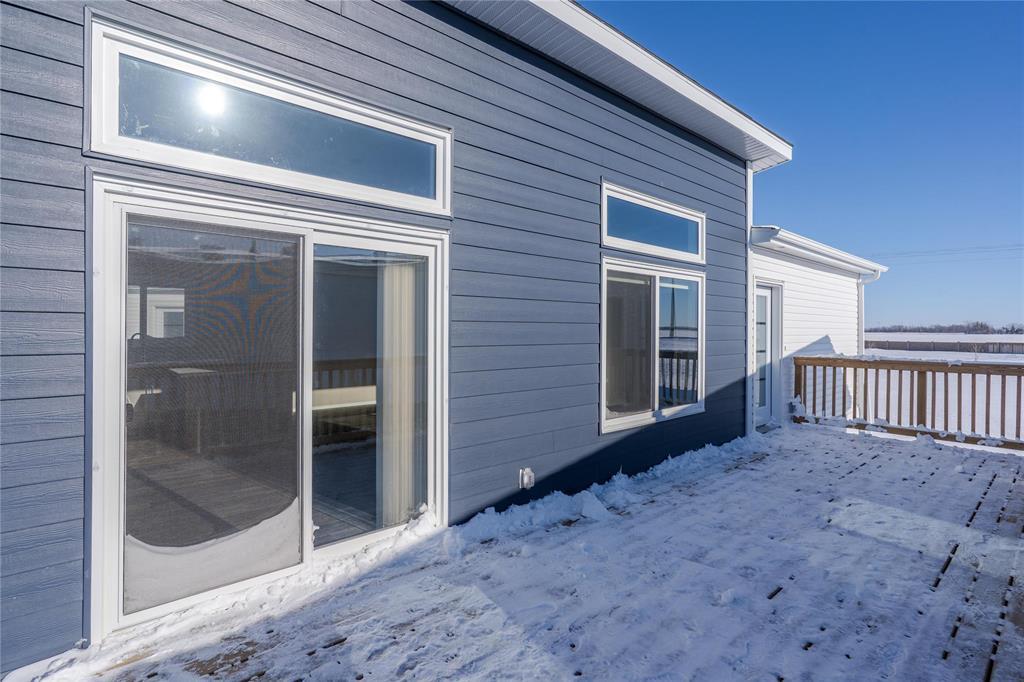 A house with a grey siding and a white door and windows.