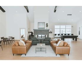 A living room with a fireplace and a large sectional sofa.