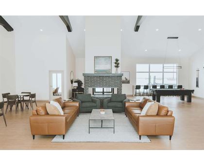 A living room with a fireplace and a large sectional sofa.