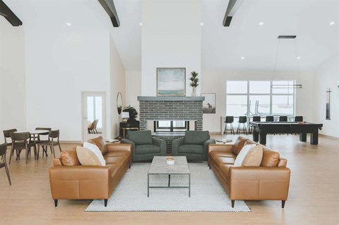 A living room with a fireplace and a large sectional sofa.