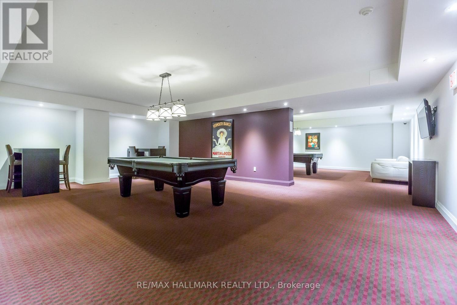 A room with a pool table and a couch.