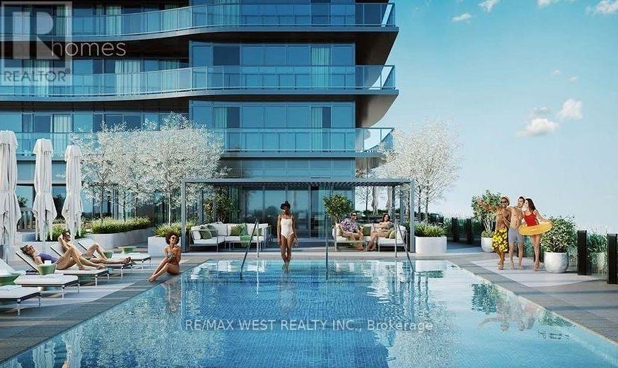 A group of people are enjoying the sun by a pool in front of a modern building.
