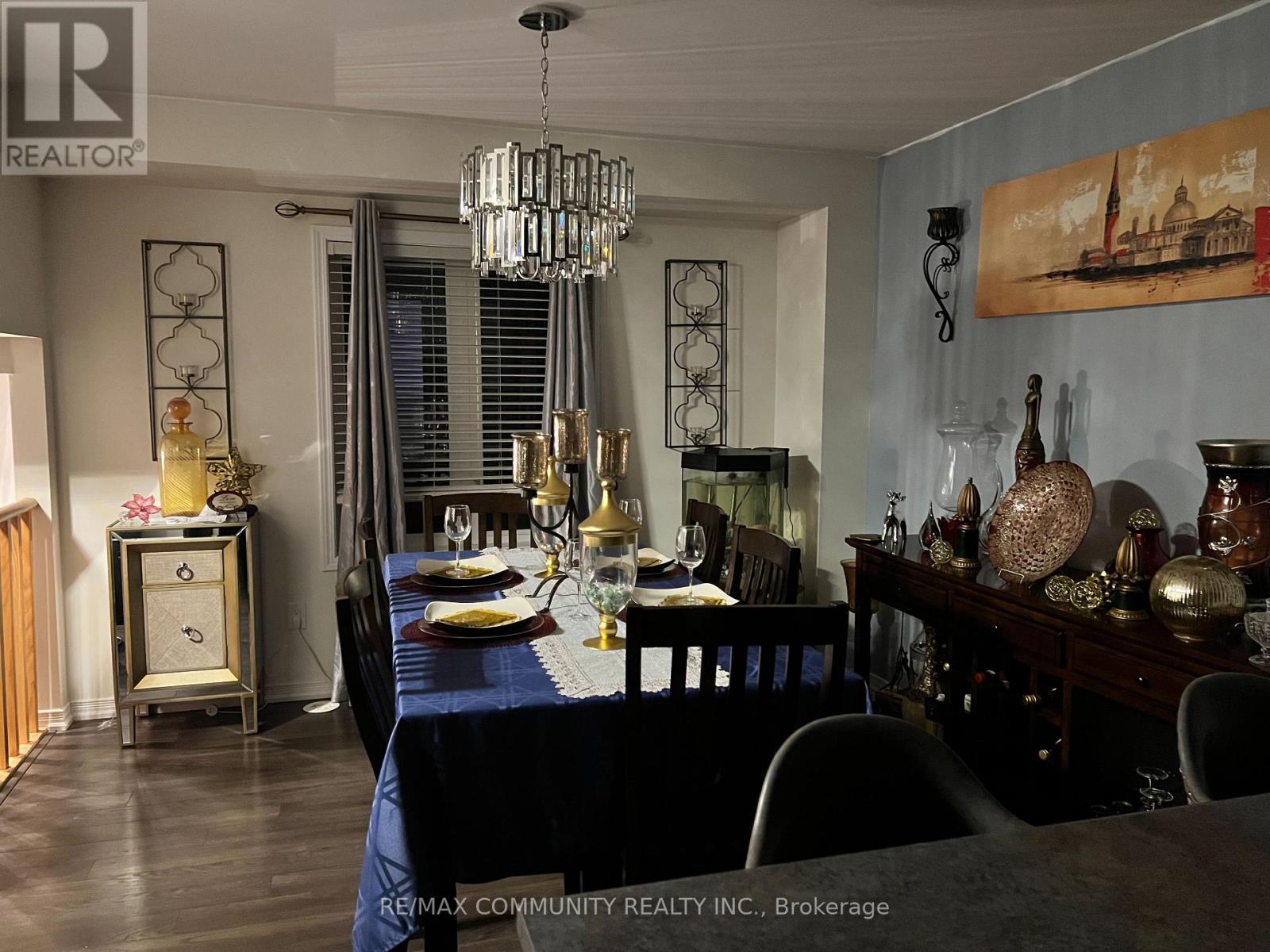 A dining room with a table set for a meal.