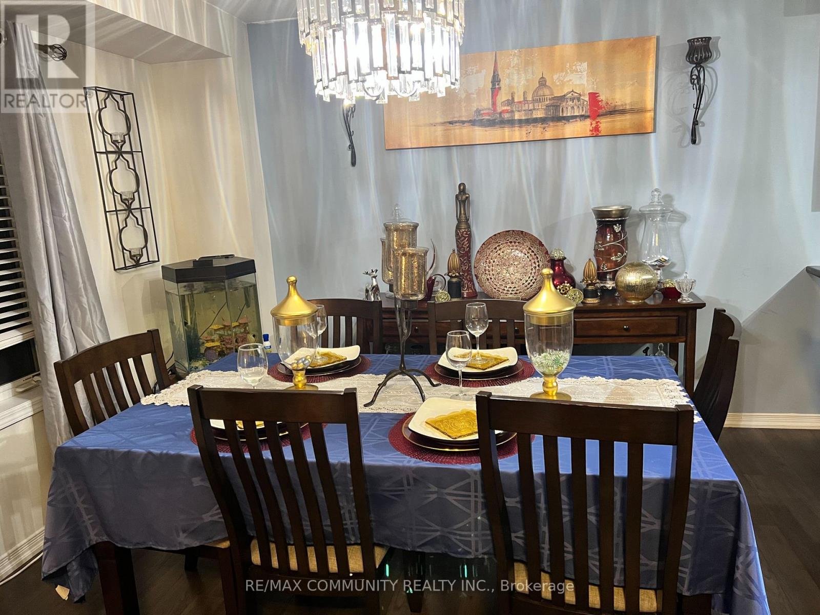 A dining room with a table set for a meal.