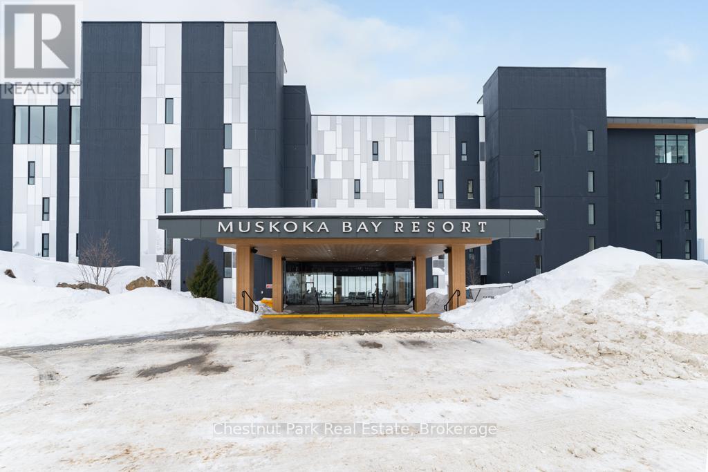A large building with a sign that says "MUSKOKA BAY RESORT".