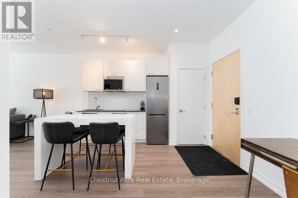 A modern kitchen with a dining table and chairs.