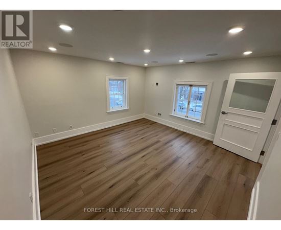 A kitchen with white cabinets and black appliances.