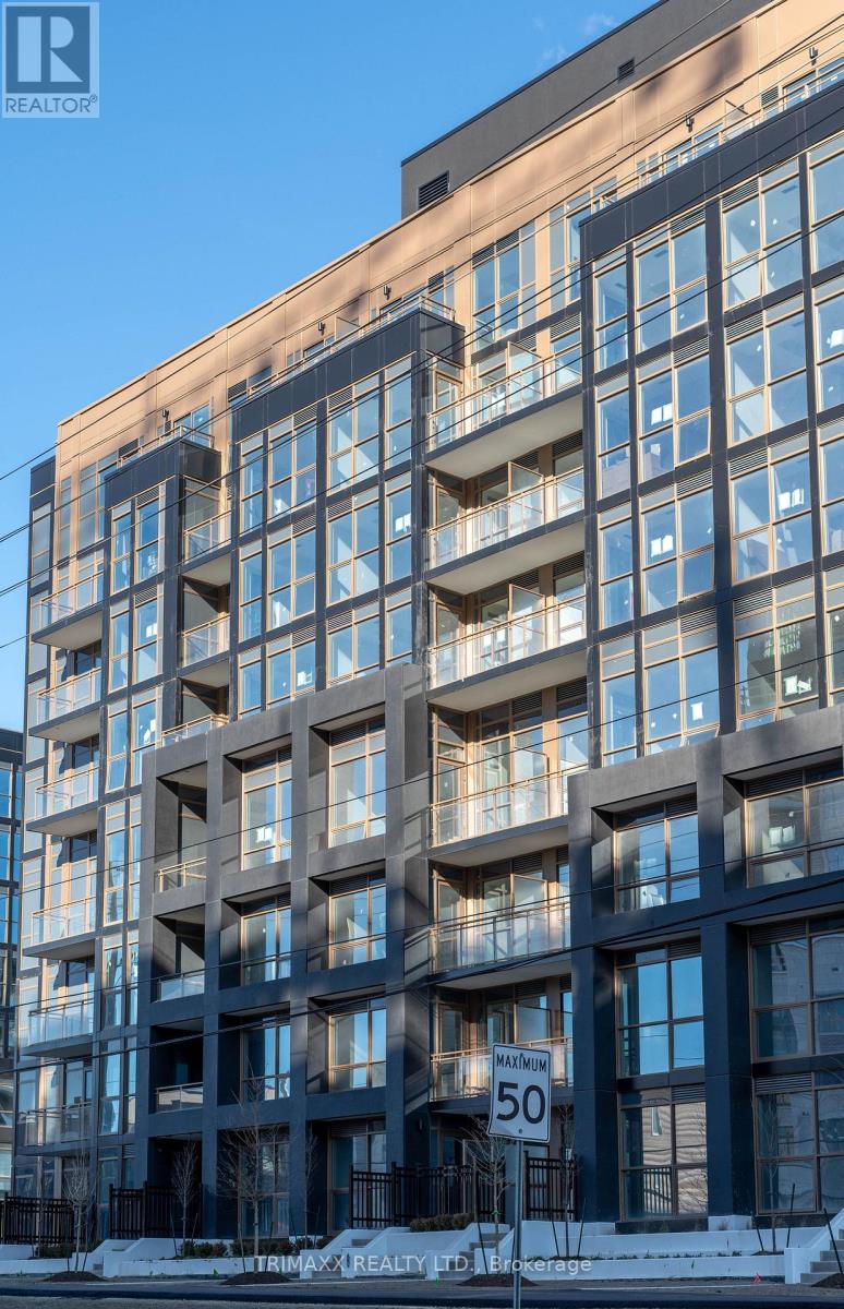 A tall building with balconies and a sign that reads 50.