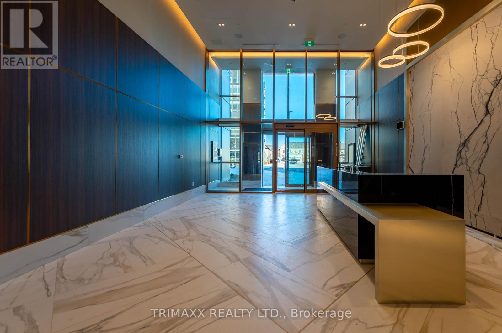 A hallway with a marble floor and a bench.