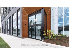 A modern building with a glass door and a sign that says REALTOR.