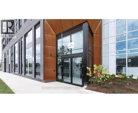 A modern building with a glass door and a sign that says REALTOR.