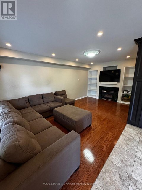 A living room with a large couch and a television.
