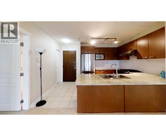 A kitchen with a sink and a microwave.