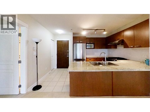 A kitchen with a sink and a microwave.