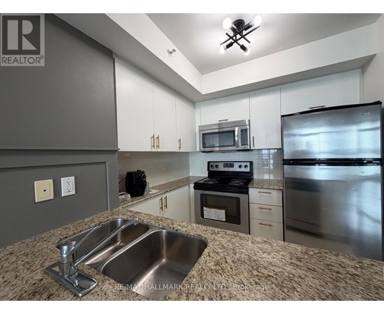A kitchen with a sink, stove, and refrigerator.