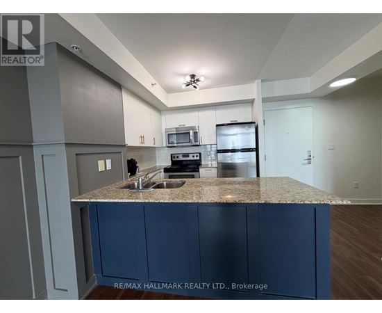 A kitchen with a granite countertop and blue cabinets.