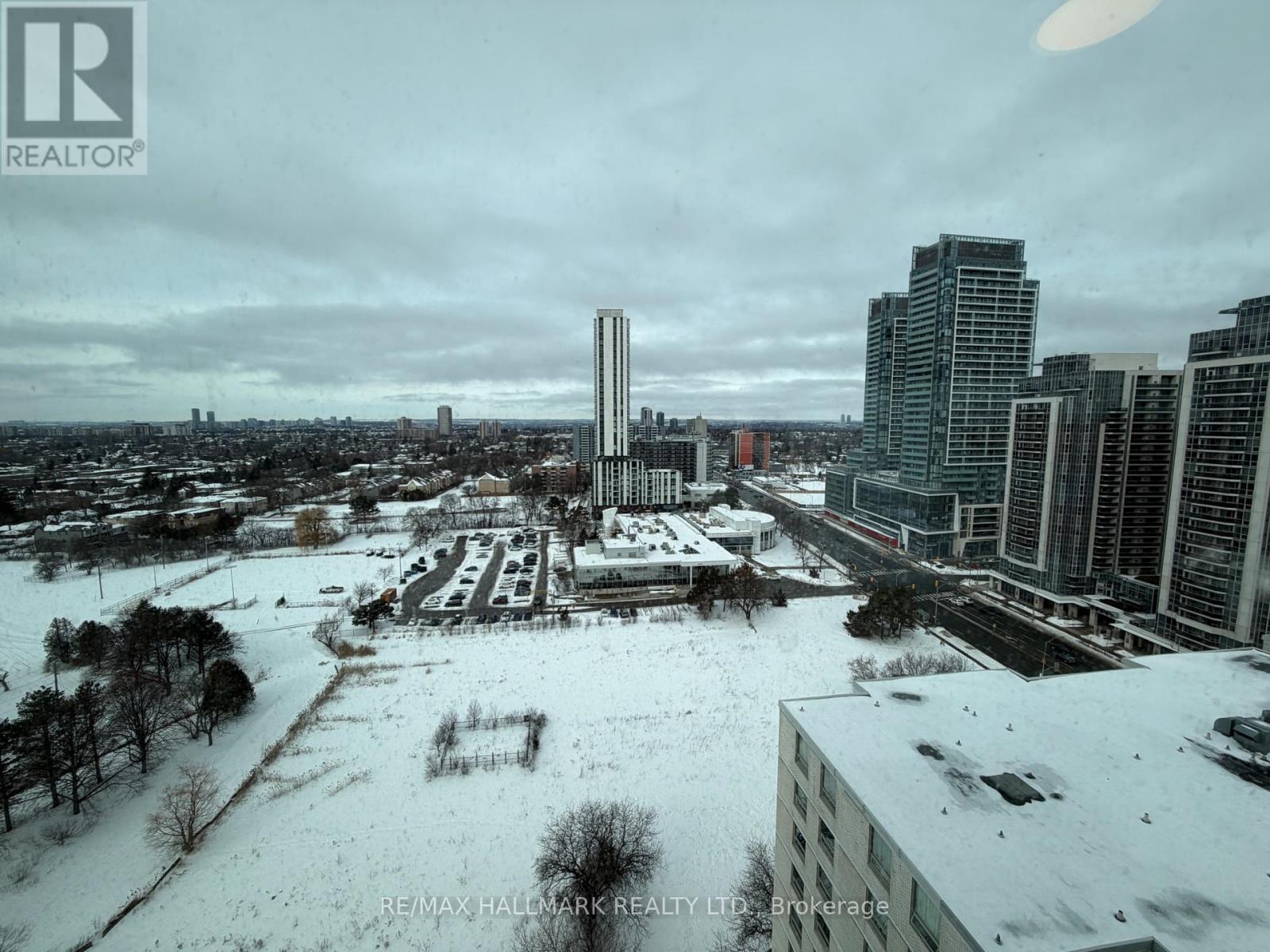 A cityscape with buildings and a snow-covered ground.