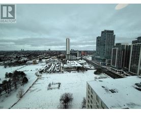 A cityscape with buildings and a snow-covered ground.