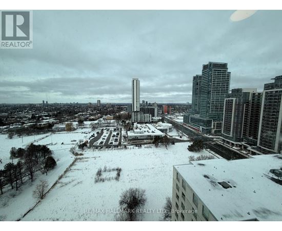 A cityscape with buildings and a snow-covered ground.