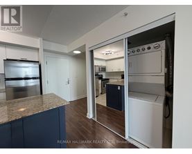 A kitchen with a granite countertop and stainless steel appliances.