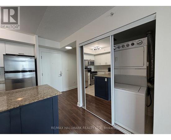 A kitchen with a granite countertop and stainless steel appliances.